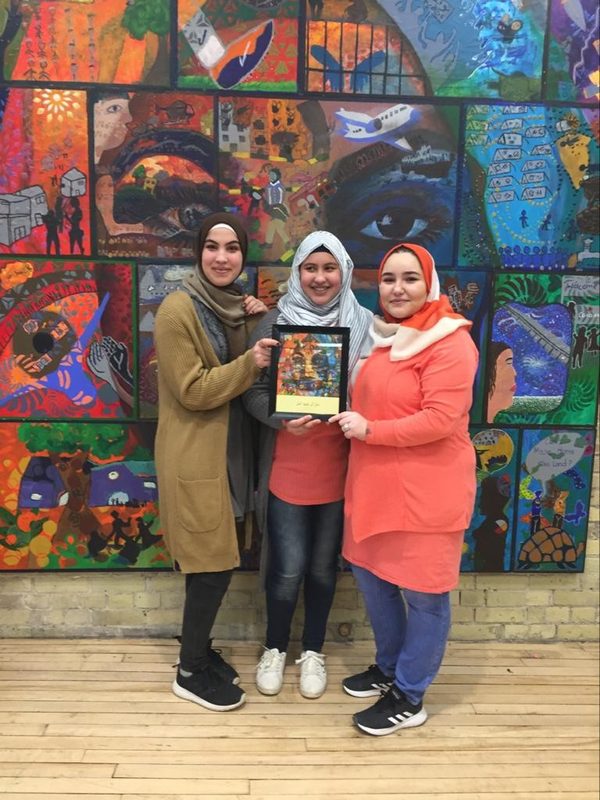 In a community. Participants with the finished wall, Syrian Youth Voices: We Still Have Hope